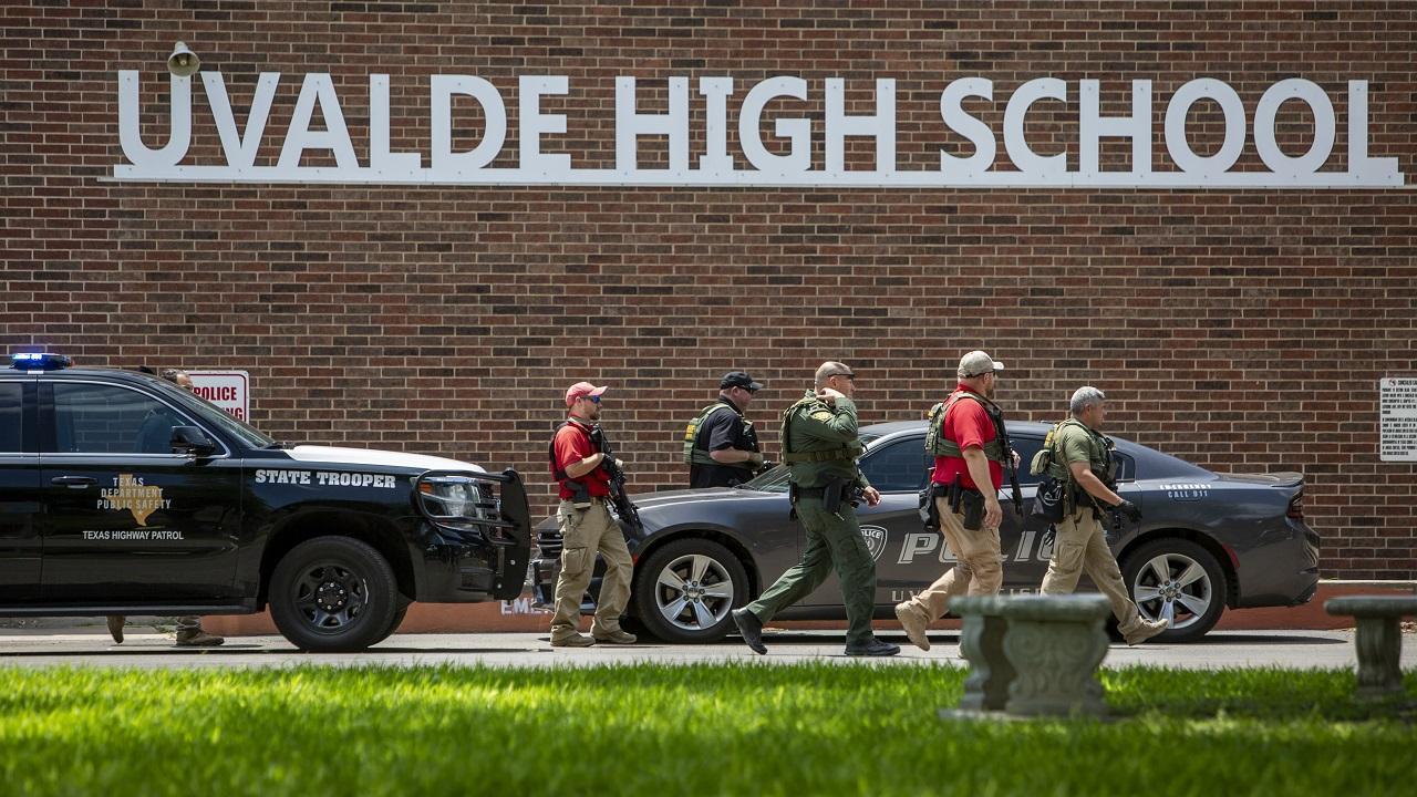 Law enforcement personnel walk outside Uvalde High School after shooting a was reported at Robb Elementary School. Pic/PTI